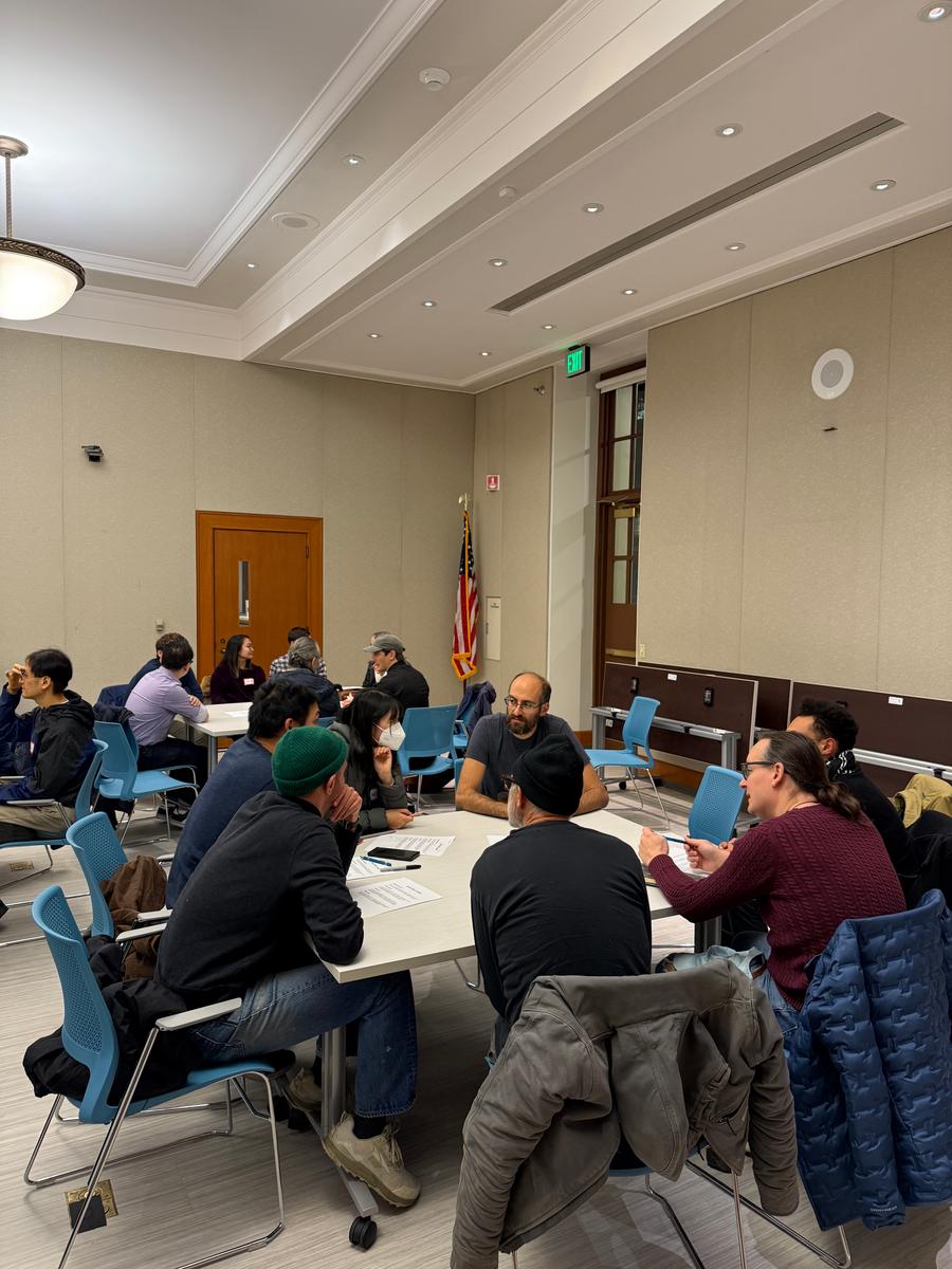 people sitting around a table in discussion